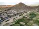Houses nestled near a lush golf course and scenic mountain, offering a harmonious blend of nature and community at 582 W Stirrup Ln, San Tan Valley, AZ 85143