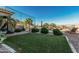 Expansive backyard featuring green grass, desert landscaping, and a sparkling pool for outdoor enjoyment at 582 W Stirrup Ln, San Tan Valley, AZ 85143