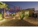 Serene backyard featuring mature desert landscaping, gravel, and a lush palm, creating a relaxing and low-maintenance outdoor space at 582 W Stirrup Ln, San Tan Valley, AZ 85143