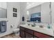 Bathroom featuring double sinks, a decorative mirror and a toilet at 582 W Stirrup Ln, San Tan Valley, AZ 85143