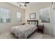 Bright bedroom with a comfortable bed, two windows, and matching nightstands at 582 W Stirrup Ln, San Tan Valley, AZ 85143