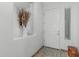 Bright entryway featuring tile flooring, a white door, and a mirrored shelf with decorative accents at 582 W Stirrup Ln, San Tan Valley, AZ 85143