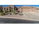 Beautiful home with drought-resistant landscaping, desert plants, and a spacious driveway at 582 W Stirrup Ln, San Tan Valley, AZ 85143