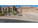 Home featuring low-water landscaping, desert plants, and a spacious two-car garage at 582 W Stirrup Ln, San Tan Valley, AZ 85143