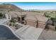 Expansive single-story home with a three-car garage, tile roof, desert landscaping and mountain views at 582 W Stirrup Ln, San Tan Valley, AZ 85143