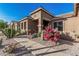 Charming single-story home with desert landscaping, including cacti and flowering plants at 582 W Stirrup Ln, San Tan Valley, AZ 85143