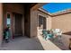 Inviting front porch with tiled flooring, outdoor seating and views of blue skies above at 582 W Stirrup Ln, San Tan Valley, AZ 85143