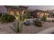 Well-manicured desert landscaping, including various cacti and gravel, surrounds this lovely home at 582 W Stirrup Ln, San Tan Valley, AZ 85143