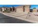 Attractive property with desert landscaping and a wide driveway leading to the garage at 582 W Stirrup Ln, San Tan Valley, AZ 85143