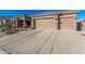 Attractive home with drought-friendly landscaping and a wide driveway leading to the garage at 582 W Stirrup Ln, San Tan Valley, AZ 85143