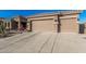 Home featuring low-water landscaping, desert plants, and a spacious two-car garage at 582 W Stirrup Ln, San Tan Valley, AZ 85143