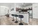 Modern kitchen with a breakfast bar, stainless steel appliances, and an open floor plan at 582 W Stirrup Ln, San Tan Valley, AZ 85143