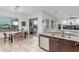 Stylish kitchen and dining area featuring granite countertops, dark wood cabinets, and stainless appliances at 582 W Stirrup Ln, San Tan Valley, AZ 85143