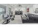 Spacious living room with plush carpeting, modern furniture, and a ceiling fan at 582 W Stirrup Ln, San Tan Valley, AZ 85143