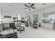 Open concept living area with cozy black leather seating, neutral carpet and stylish decor at 582 W Stirrup Ln, San Tan Valley, AZ 85143
