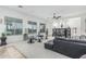 Airy living room with a large window, plush carpet, and a cozy seating arrangement at 582 W Stirrup Ln, San Tan Valley, AZ 85143