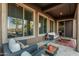 Charming patio with cozy seating, stylish décor, and large windows offering serene outdoor views and natural light at 582 W Stirrup Ln, San Tan Valley, AZ 85143