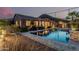 Inviting backyard pool with desert landscaping, lush greenery, and charming lounge area, perfect for relaxing evenings at 582 W Stirrup Ln, San Tan Valley, AZ 85143