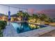 Sparkling pool surrounded by lush landscaping and comfortable seating areas for relaxation at 582 W Stirrup Ln, San Tan Valley, AZ 85143