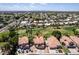 Picturesque aerial view of a neighborhood with single-Gathering homes and a golf course, set against a backdrop of distant mountains at 5953 W Aurora Dr, Glendale, AZ 85308