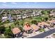 Expansive aerial view of a community with lush golf courses and houses with red tiled roofs under a clear, blue sky at 5953 W Aurora Dr, Glendale, AZ 85308