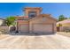 Front exterior of a two-story house featuring a three-car garage, desert landscaping, and tiled roof at 5953 W Aurora Dr, Glendale, AZ 85308