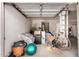 Cluttered garage interior with storage items, bicycle, and exercise equipment at 5953 W Aurora Dr, Glendale, AZ 85308