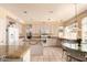 Bright kitchen featuring ample cabinet space, an island, and a dining area overlooking the backyard at 5953 W Aurora Dr, Glendale, AZ 85308