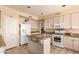 Spacious kitchen with white cabinets, a kitchen island, and stainless steel appliances at 5953 W Aurora Dr, Glendale, AZ 85308