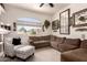 Comfortable living room features a large window, plush seating, and decor at 5953 W Aurora Dr, Glendale, AZ 85308
