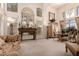 Formal living room with high ceilings, large windows, and elegant furnishings, including a dining table at 5953 W Aurora Dr, Glendale, AZ 85308