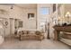 Spacious living room with high ceilings, a large mirror above the fireplace, and elegant, comfortable seating at 5953 W Aurora Dr, Glendale, AZ 85308