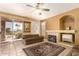 Living room with tile floors, sliding glass doors, and neutral decor at 5953 W Aurora Dr, Glendale, AZ 85308