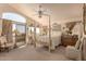 Spacious main bedroom with a four-poster bed, neutral tones, and natural light at 5953 W Aurora Dr, Glendale, AZ 85308