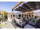 Inviting backyard with multiple seating areas, mature landscaping, and a pergola for shade at 6314 N 14Th St, Phoenix, AZ 85014