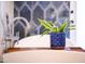 Close up on a chrome faucet, blue potted plant, and luxurious white bathtub with wood caddy at 6314 N 14Th St, Phoenix, AZ 85014