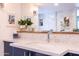 Bathroom vanity featuring white countertop, mosaic backsplash, decorative lighting, and a large mirror at 6314 N 14Th St, Phoenix, AZ 85014