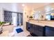 Bright bathroom featuring an undermount sink, soaking tub, and walk-in shower with decorative blue tile at 6314 N 14Th St, Phoenix, AZ 85014