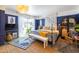 Bright bedroom with a four-poster bed, blue walls, and a view of the outdoor greenery at 6314 N 14Th St, Phoenix, AZ 85014
