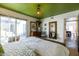 Bright bedroom with a green ceiling, leading to a patio and glimpses of a modern kitchen at 6314 N 14Th St, Phoenix, AZ 85014