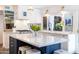 Bright kitchen showcasing white cabinets, marble countertops, stainless steel appliances and a large window over the sink at 6314 N 14Th St, Phoenix, AZ 85014