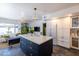 Bright kitchen featuring a navy-blue island, stainless steel appliances, and an open-concept layout to the living area at 6314 N 14Th St, Phoenix, AZ 85014