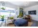 Bright living room boasts a large picture window, a stylish white sofa, and views of the well-manicured backyard at 6314 N 14Th St, Phoenix, AZ 85014