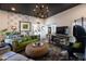 Inviting living room with eye-catching chandelier, modern television, and plants at 6314 N 14Th St, Phoenix, AZ 85014