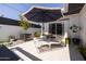 Stylish patio features lounge chairs, accent tables, citrus tree, and an umbrella for outdoor living at 6314 N 14Th St, Phoenix, AZ 85014