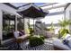 Cozy outdoor patio with stylish seating, potted plants, and an umbrella for shade at 6314 N 14Th St, Phoenix, AZ 85014