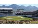 A beautiful view of the 16th hole at the Waste Management Open golf course with grandstands and mountain views at 6351 E Waltann Ln, Scottsdale, AZ 85254