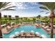 A luxury resort pool surrounded by palm trees and lounge chairs offers a tranquil getaway for relaxation at 6351 E Waltann Ln, Scottsdale, AZ 85254