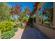 A beautiful patio is adjacent to the house, alongside lush greenery and colorful blooms creating a serene outdoor retreat at 650 E Myrtle Pass, Queen Creek, AZ 85140