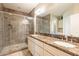 Bathroom features double sinks, granite counters, a walk-in shower with stone floor at 650 E Myrtle Pass, Queen Creek, AZ 85140